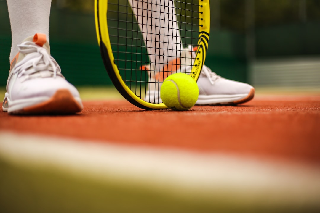 person-in-white-nike-sneakers-playing-tennis-k0avmmzwqtu